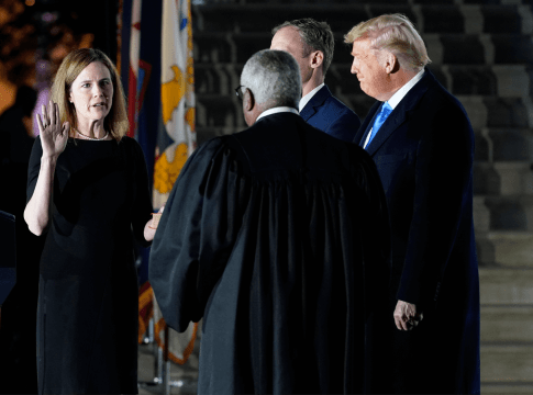 President Donald Trump watches as Supreme Court Justice Clarence Thomas administers the Constitutional Oath to Amy Coney Barrett on the South Lawn of the White House in Washington, Monday, Oct. 26, 2020, after Barrett was confirmed by the Senate earlier in the evening.