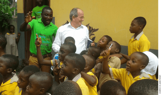 Professor James Tooley with students at an Omega private school in Bawjiase, Ghana.