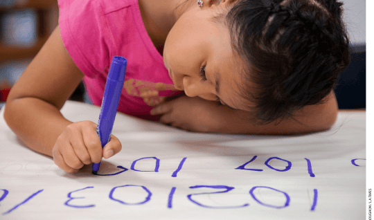 Emily Osorio-Hernandez, 6, writes numbers for a math assignment at a California elementary school in 2019. The Golden State unveiled new proposed math guidelines in 2021.