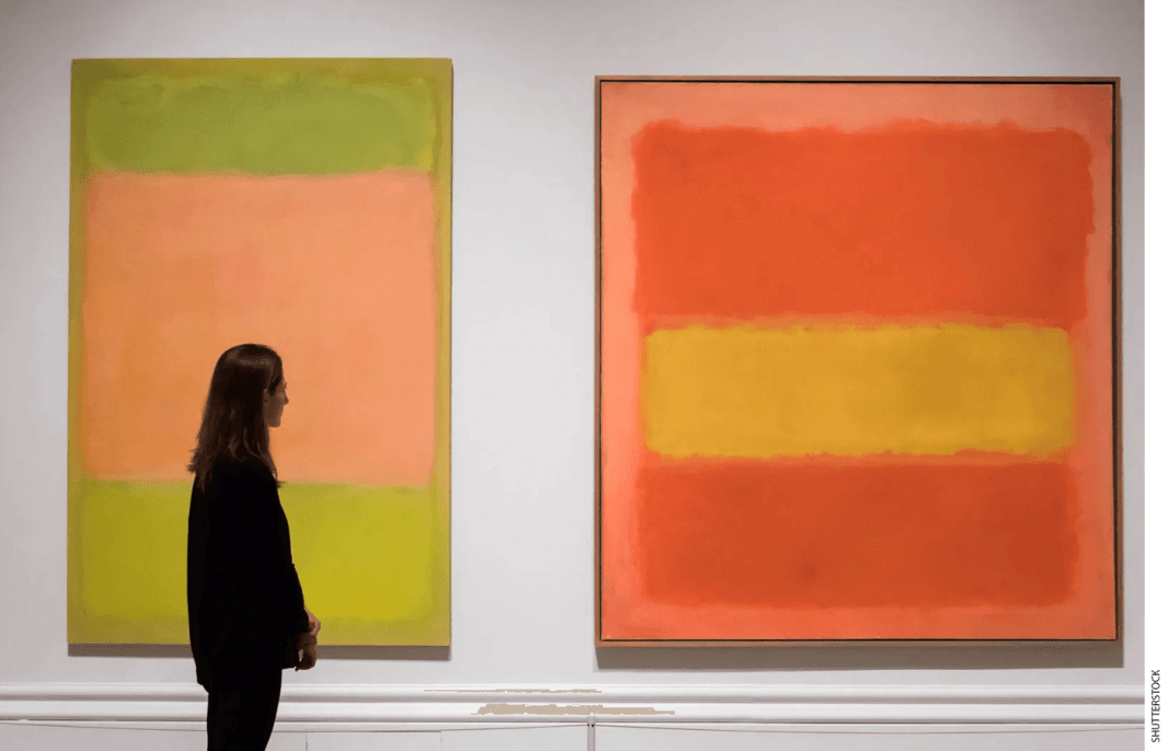 A person stands in front of two Mark Rothko paintings