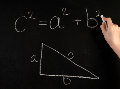 Hand writing out Pythagoras Theorem on chalkboard