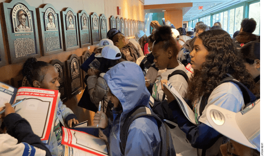 Students from the 6th grade at Nathan Hale School complete a "bingo challenge" as part of the Red Sox Hall of Fame stop on their guided tour of the Fenway Park Learning Lab.
