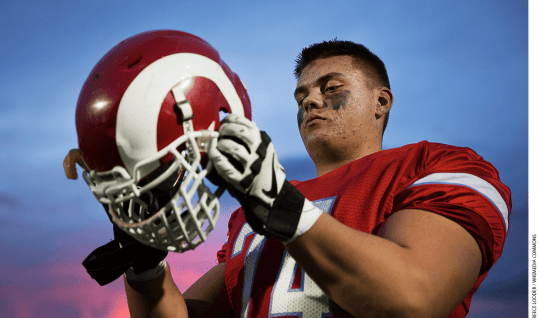 Shane Lemieux, a offensive tackle for the West Valley High School Rams varsity football team and 17-year-old native of Yakima, Wash., dons his helmet before a game against the Wenatchee High School Panthers at West Valley High School in Yakima, Wash., Oct. 31, 2014.